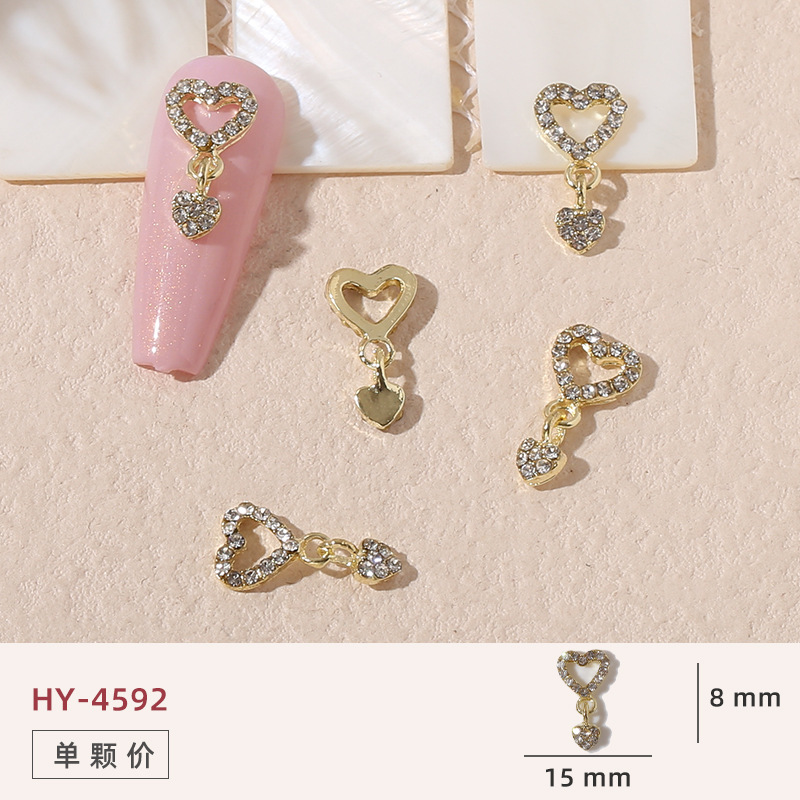 Uñas mariposa joyería nueva línea popular perla arco metal decoración de uñas pequeños accesorios de joyería al por mayor