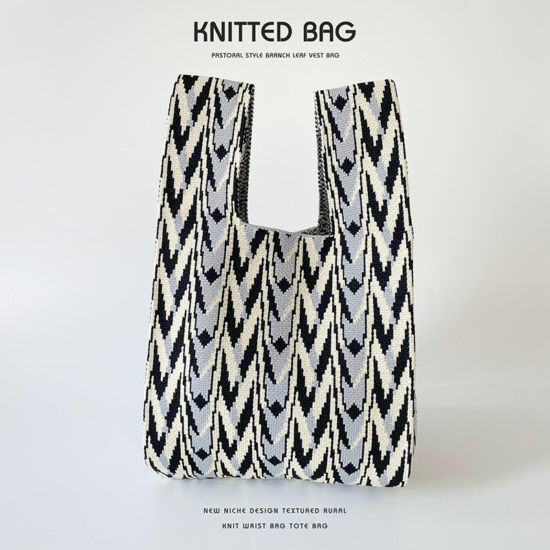 Bolsa de diseño de nicho de punto bolso de hombro bolso de mano simple de gama alta todo-fósforo de gran capacidad estudiante bolso de la muñeca