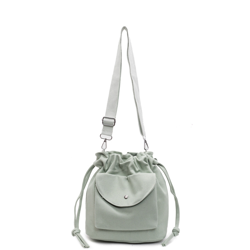 Bolsa de cubo de lona de moda de comercio exterior para mujeres 2025 nuevo estilo versátil bolso de hombro simple ocio nicho plegado mochila