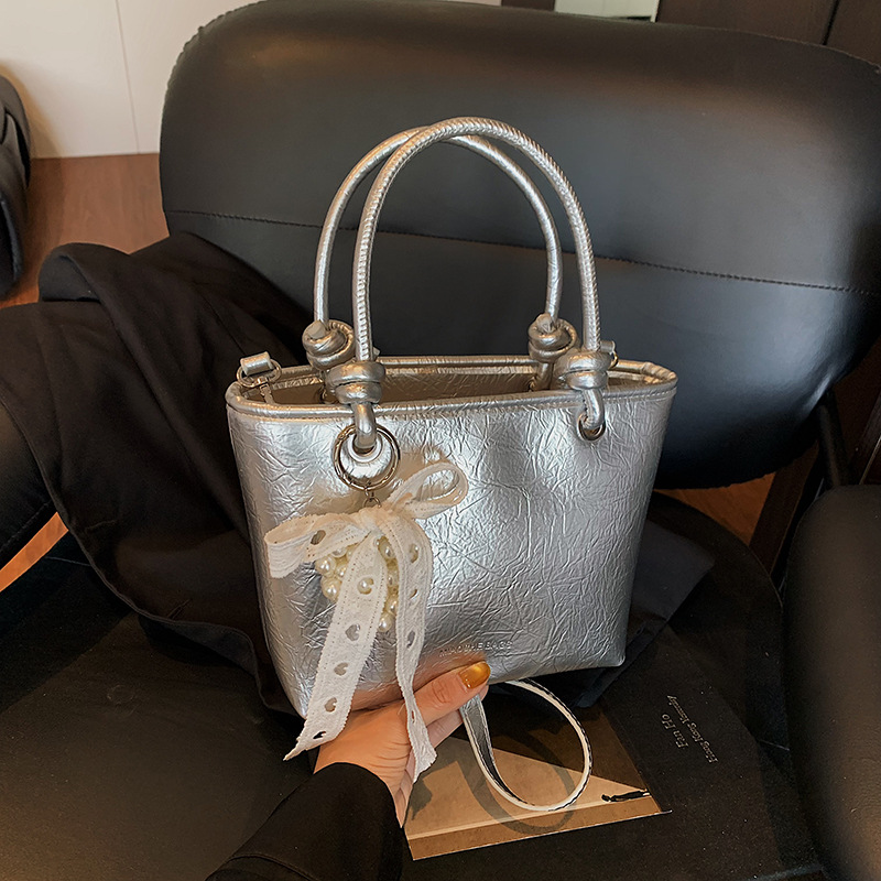 Bolso de mujer PU al por mayor transfronterizo 2025 nuevo bolso de mensajero de un solo hombro casual simple bolso de cubo de agua súper caliente de alta gama de verano