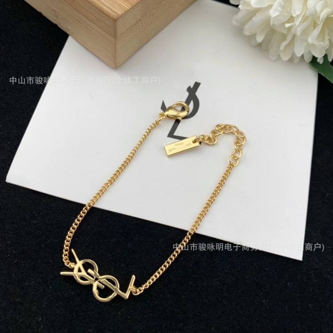 golden glossy minimalistic bracelet with letters