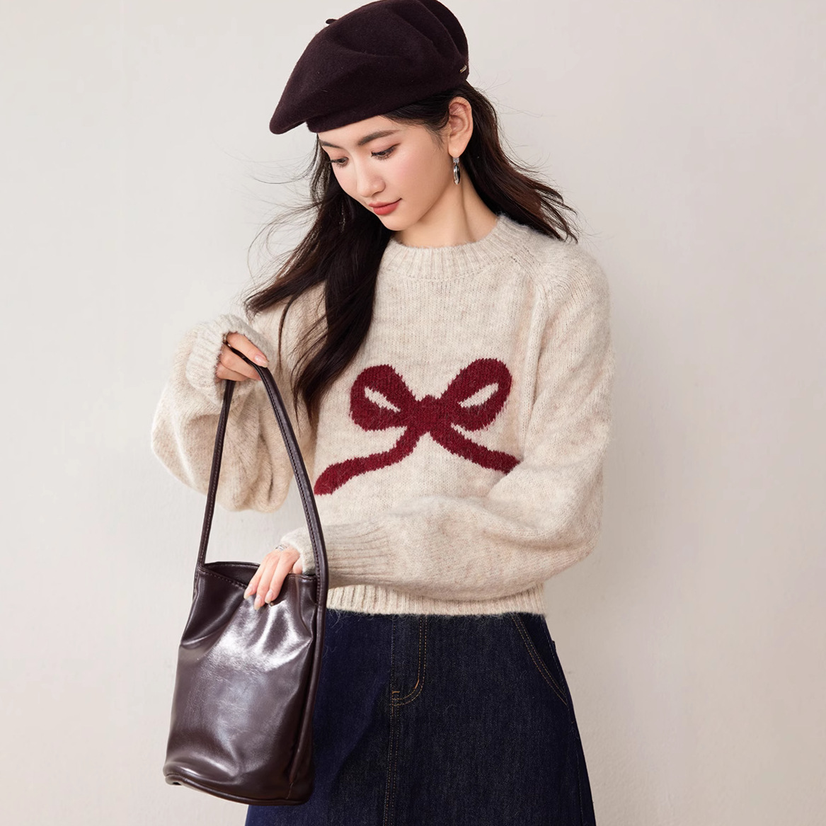 Winter knitted sweater with a round collar with bow