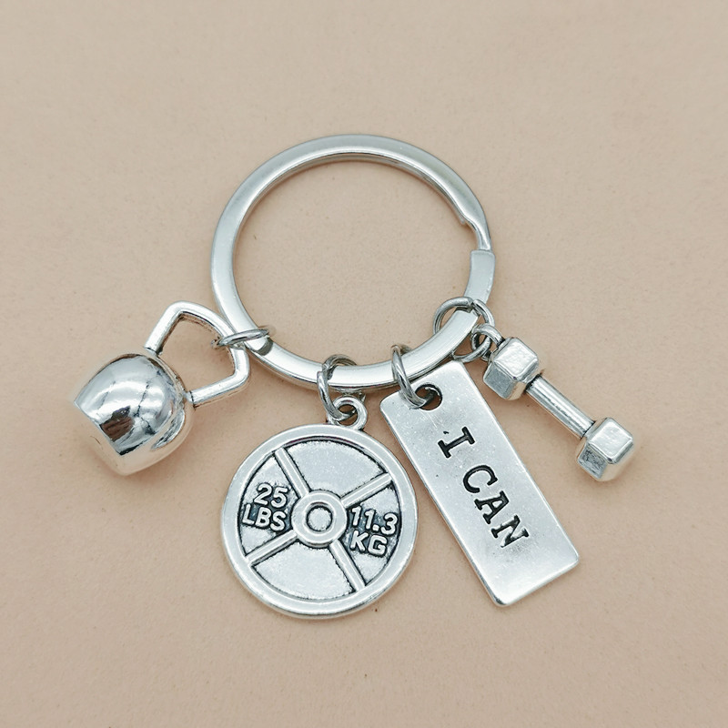 Nueva joyería europea y americana deportes poder mancuerna barra hervidor campana llavero hombres y mujeres pareja amistad llavero