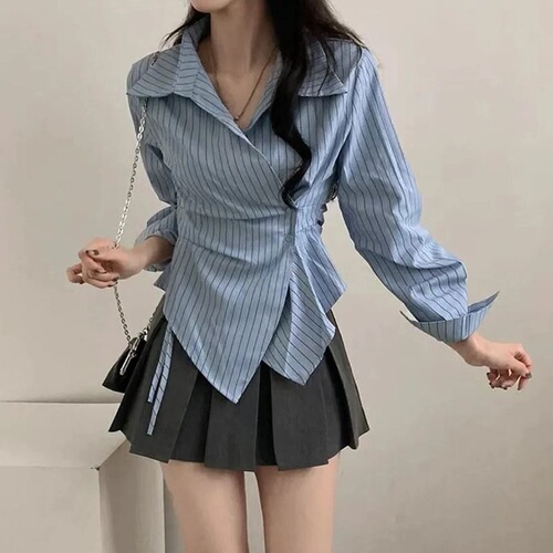 A stylish women's new spring collared shirt with a design featuring irregular cinched waist for a slimming effect, striped long sleeves, and a trendy vibe.