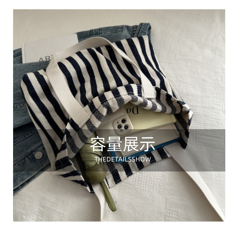 The new cross-border vertical striped commuter tote bag, hand-held shoulder bag, is fashionable and has a large capacity. It features an InS-style simple letter sail undefined