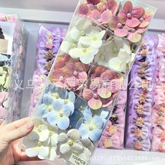 甘い真珠の胡蝶蘭の少女の花の髪は新型の雰囲気を挟んで写真を撮ります。