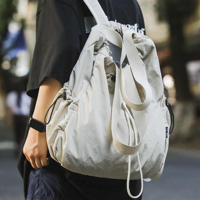 Mochila de nailon con cordón para mujer 2024 nuevo bolso de cubo de doble uso de un solo hombro literario simple para estudiantes universitarios