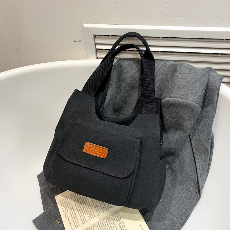 2024 invierno nuevo paquete de viaje japonés retro nicho sensación de diseño bolso de lona simple color sólido bolso casual