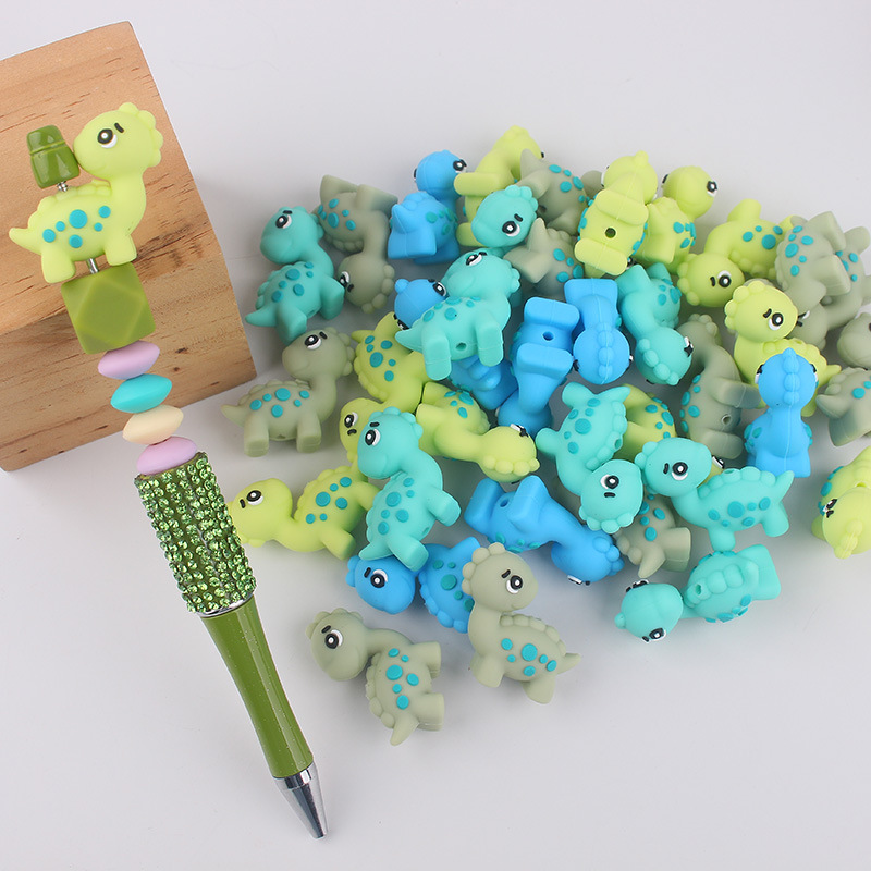 Dibujos animados Dinosaur Dental Topeador Cuentas de goteo Bolígrafo de cuentas de bricolaje Pezones para bebés Cadena anti-caída Amazon