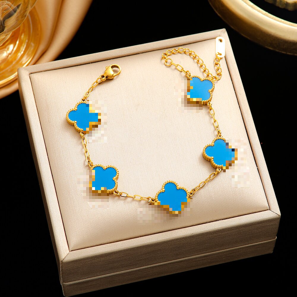 Pulsera de trébol de acero titanium vendedora caliente transfronteriza europea y americana con incrustaciones de concha pulsera colgante pulsera de diseño avanzado sin desvanecimiento al por mayor