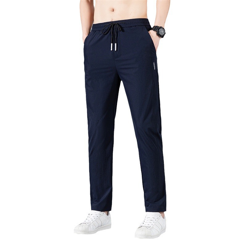Pantalones largos delgados de verano para hombres tendencia universal de hielo rápido secado deportivo relajado grande pantalones casuales al por mayor