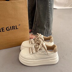 厚い底の白い靴を履いています。女性は高くなります。