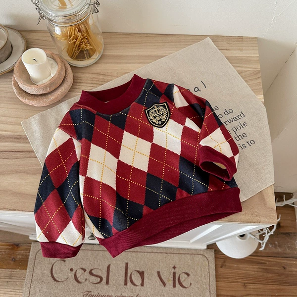 Badge, red colored sweater