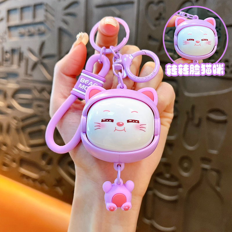 Llavero creativo de dibujos animados girando música lindo descompresión cambio de cara llavero de gato bolsos para hombres y mujeres pequeños regalos al por mayor