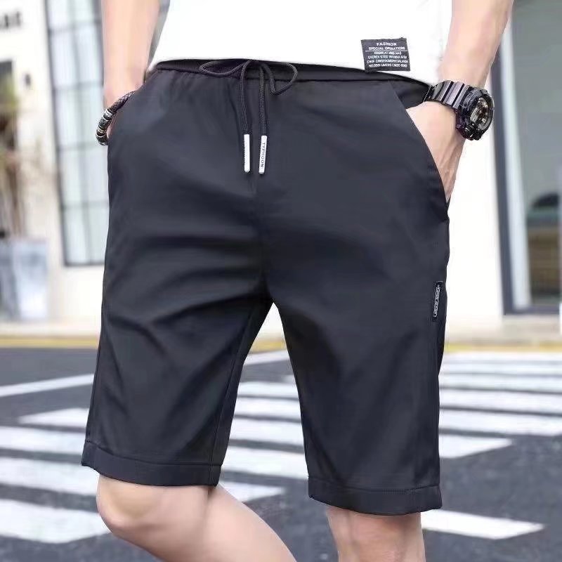 Pantalones cortos de seda de hielo para hombres 2020 Verano nuevo estilo coreano suelto elástico costura etiquetado pantalones cortos de playa