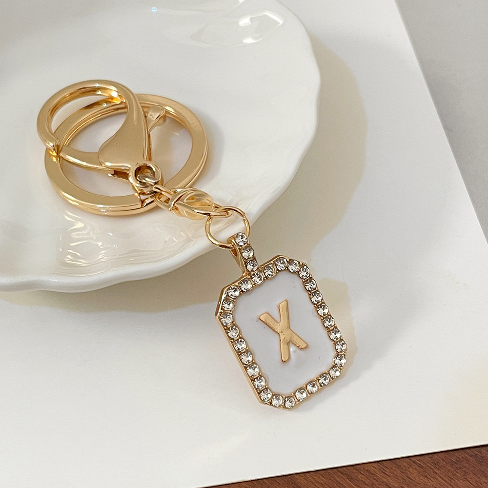 Nueva moda 26 cartas gota de diamante aceite llavero bolso del auricular pareja colgante vacaciones pequeño regalo al por mayor