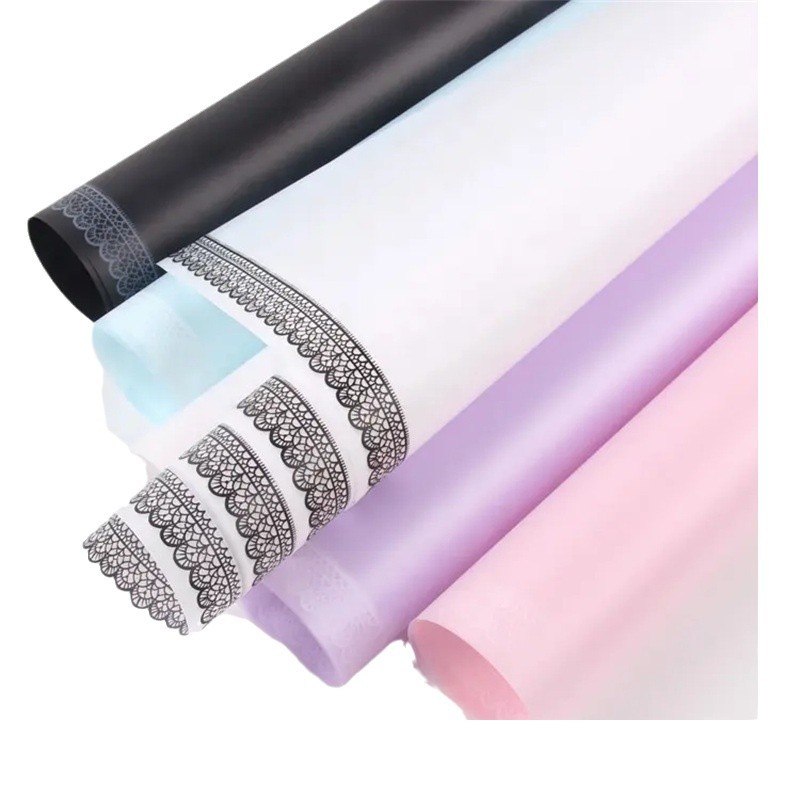 Fábrica de fiestas de flores al por mayor encaje papel de embalaje de flores impermeable semipermeable papel de niebla papel de embalaje de ramo de flores sólidas