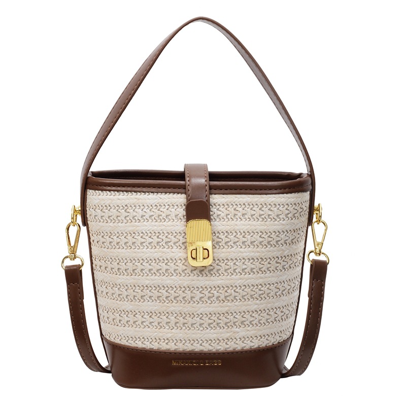 Bolso de cubo de paja de mano popular de verano 2025 nuevo bolso de mensajero tejido de vacaciones junto al mar con textura bolso femenino de todo fósforo