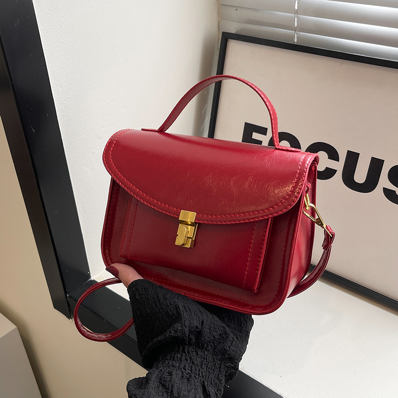 Bagos portátiles de estilo extranjero 2025, primavera nueva moda de nicho, bolsos de hombro de moda, bolsos de bloqueo personalizados, bolsos de mujer de tramo inclinado