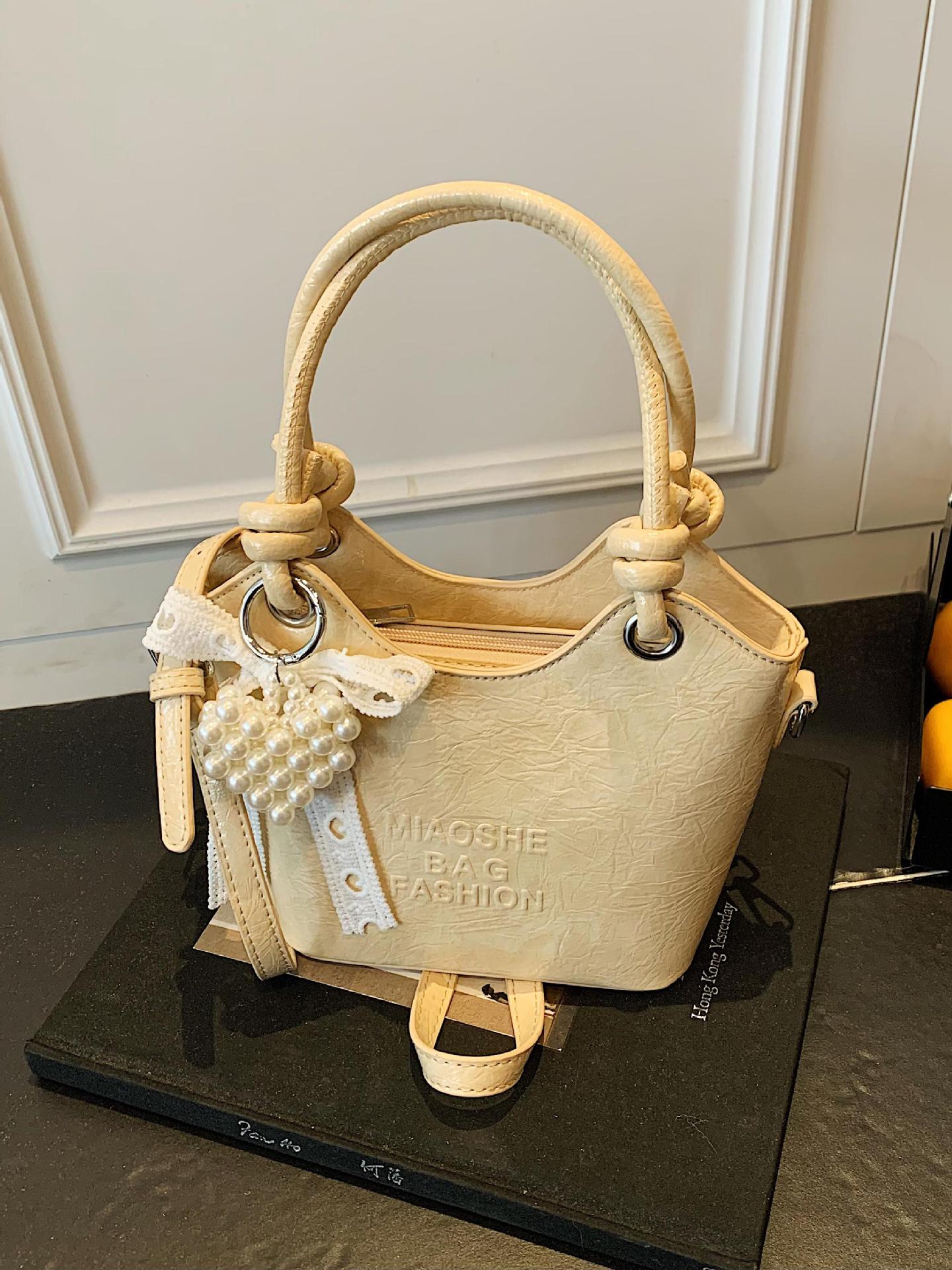 Bolso de mano de estilo occidental de ocio para mujer 2025 nuevo producto de moda de cercanías bolso de mensajero de un solo hombro de todo fósforo bolso de cubo de cuero de cera de aceite