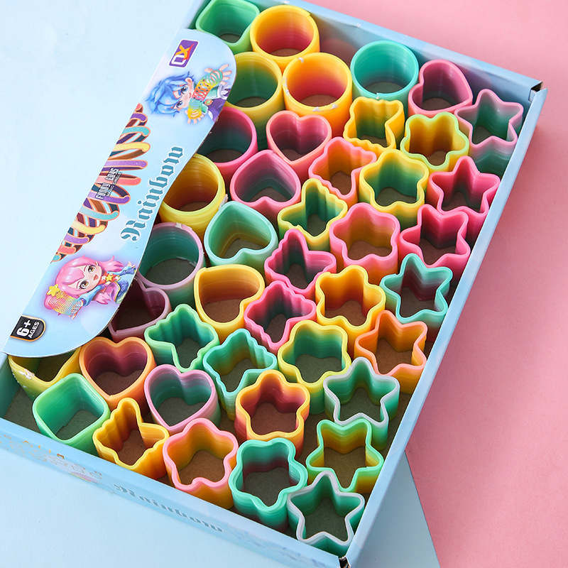 Fábrica directa pequeña mágica arco iris círculo de estudiantes juguetes de puzzle mini bobina de forma extraña mercado nocturno tienda de suministro