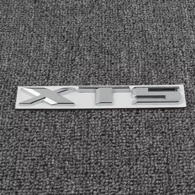 models; silver rear emblem – Car logo - standard-old-model-xts-in-bright-silver