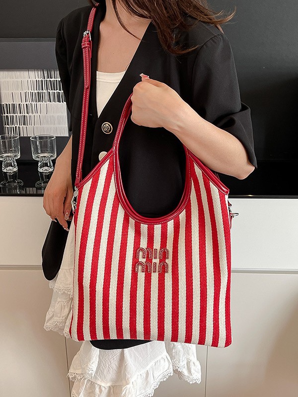 Bolsa de hombro a rayas de lona 2026 nueva sensación de lujo ligera casual diaria gran capacidad mochila