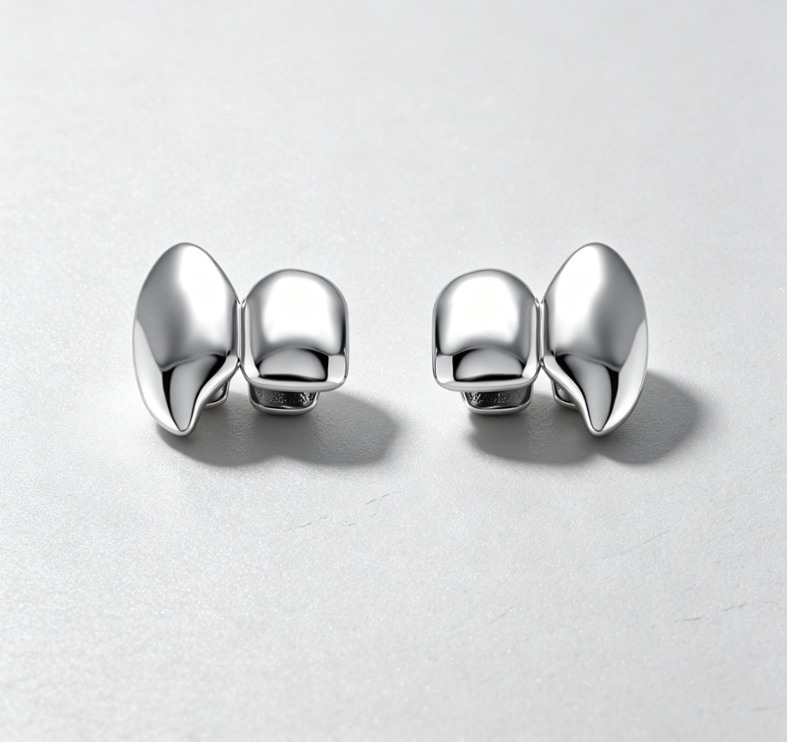 A pair of silver horn teeth