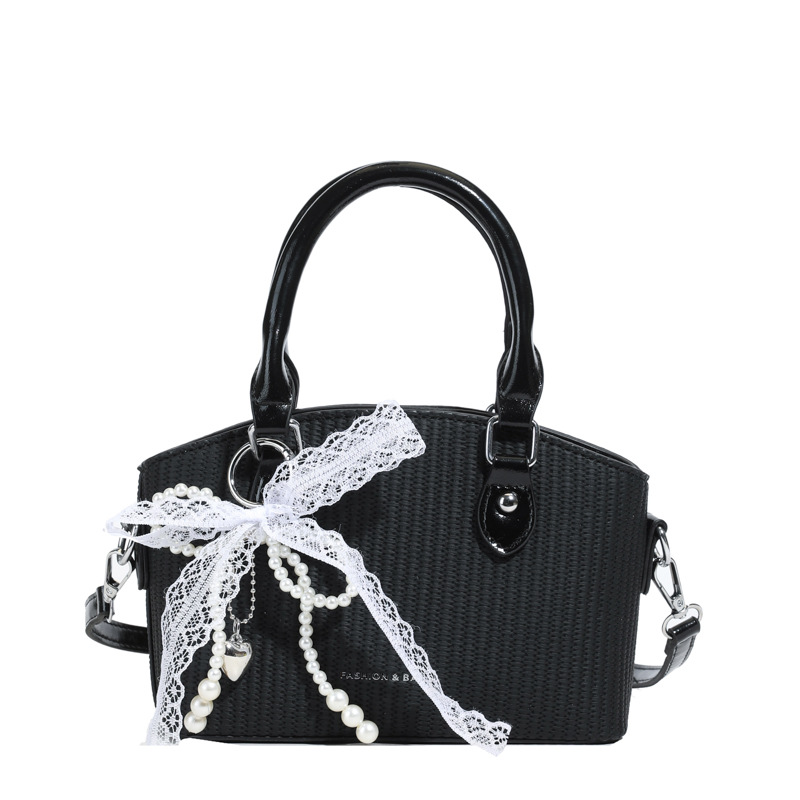 Vacaciones de verano en la playa de viajes bolsa de conchas de arena mujer 2025 este año bolsa de paja popular nueva bolsa de hombro tejida