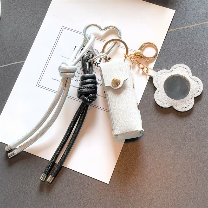 Espejo de cuero transfronterizo lápiz labial bolsas de llaves creativas flores portátiles maquillaje espejo bolsas colgantes accesorios de llaves PU