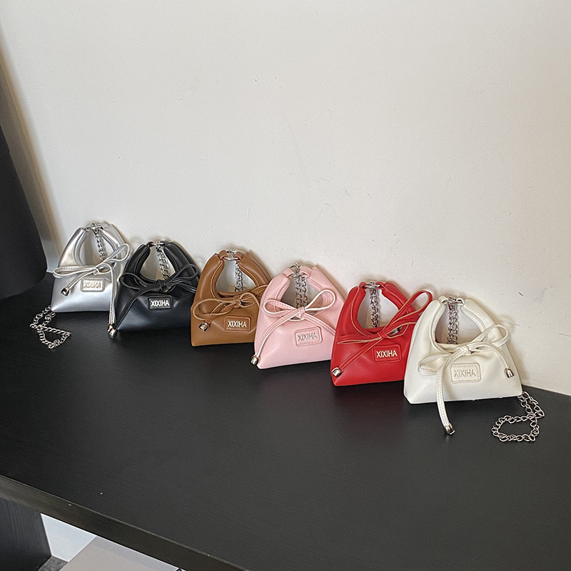 Bolsa de tendencia coreana para niñas, mini bolso de mano simple de color sólido, bolso de accesorios para niños de arco lindo