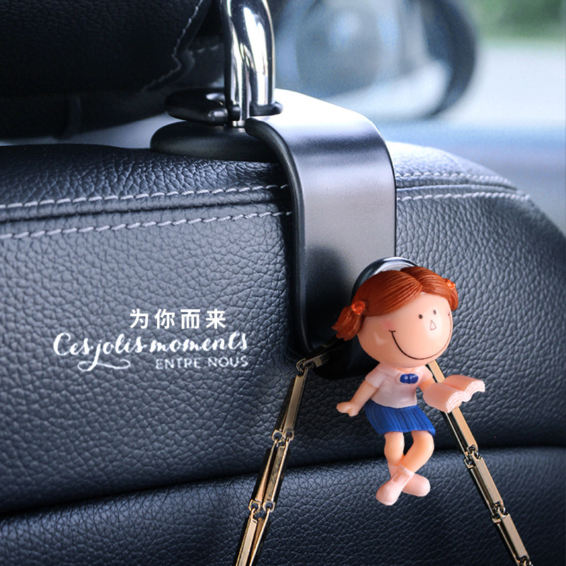 Accesorios interiores de automóviles transfronterizos gancho trasero gancho de asiento de automóvil pareja encantadora lectura de dibujos animados muñeca popularidad en línea