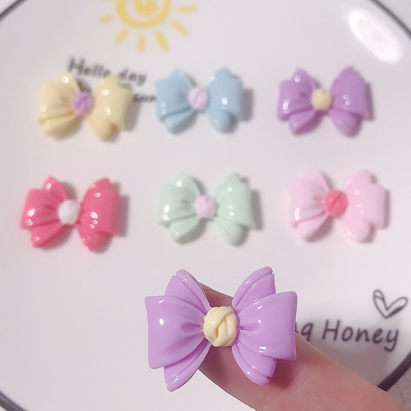 Nuevos accesorios de resina de color macaron de lazo de dibujos animados
