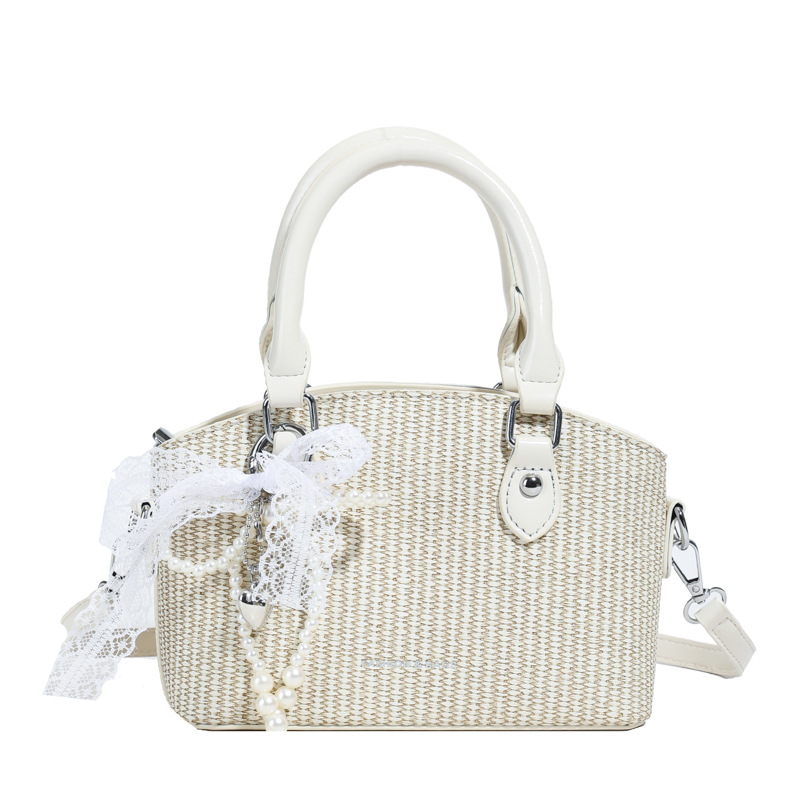 Vacaciones de verano en la playa de viajes bolsa de conchas de arena mujer 2025 este año bolsa de paja popular nueva bolsa de hombro tejida