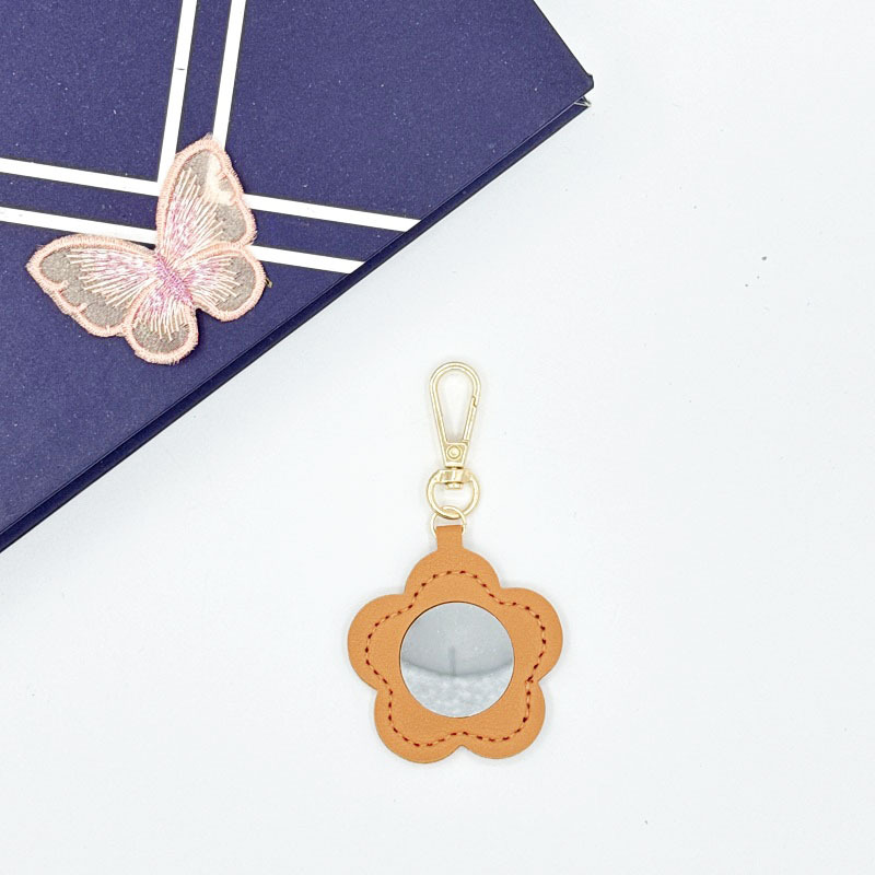 Flor espejo llavero cuero transfronterizo regalo colgante joyería creativo mini lápiz labial almacenamiento llavero colgante