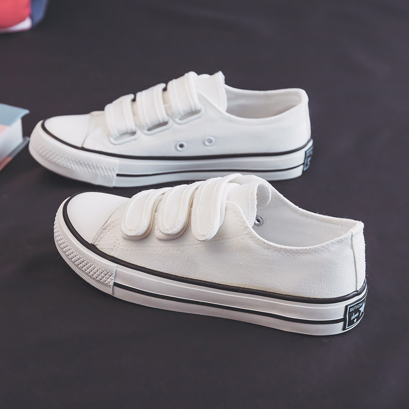 2026 primavera nuevo velcro baja zapatos blancos coreanos zapatos de lona de fijación zapatos casuales para mujeres zapatos de pareja