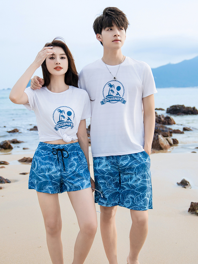Pareja en stock, pantalones de playa rápidos y sueltos junto al mar, pantalones cortos deportivos de hombre, pantalones casuales de cinco puntos.
