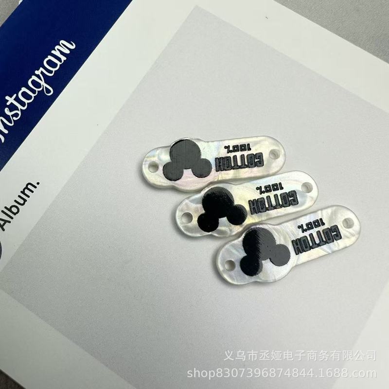 现货仿贝树脂商标吊牌字母椭圆蝴蝶结衣标高端百搭装饰纽扣60款|undefined
