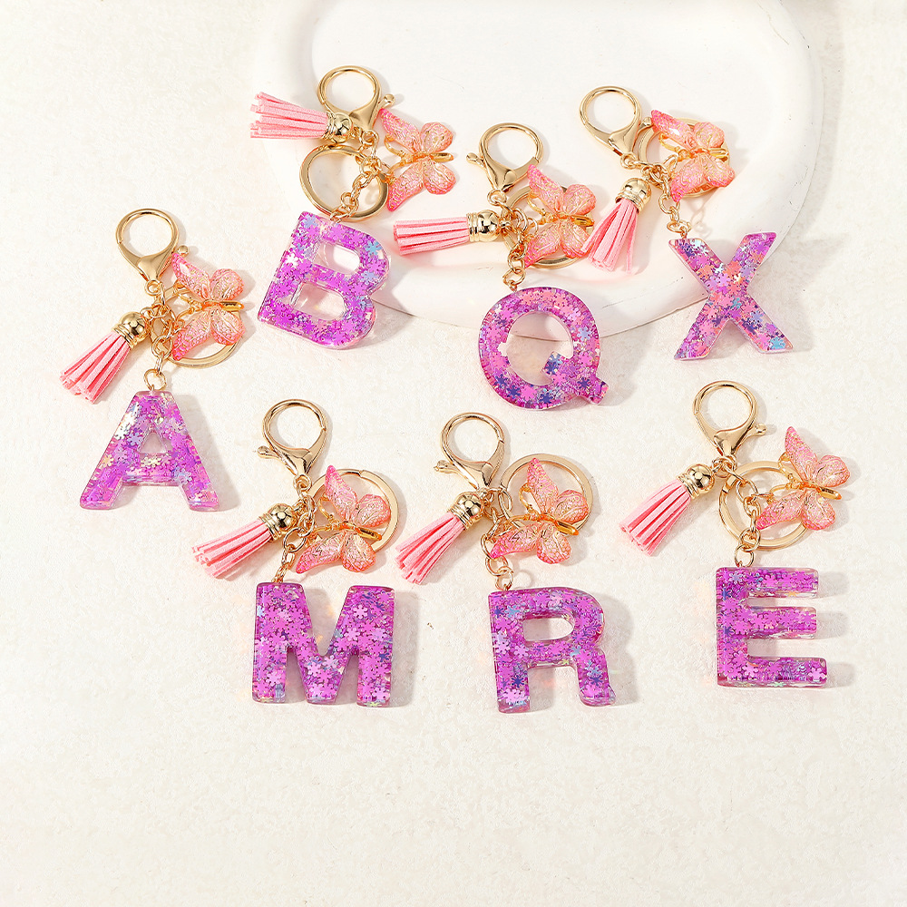 Nuevo color púrpura claro mezcla de polvo brillante letras inglesas resina llave colgante estilo simple mariposa borda colgante