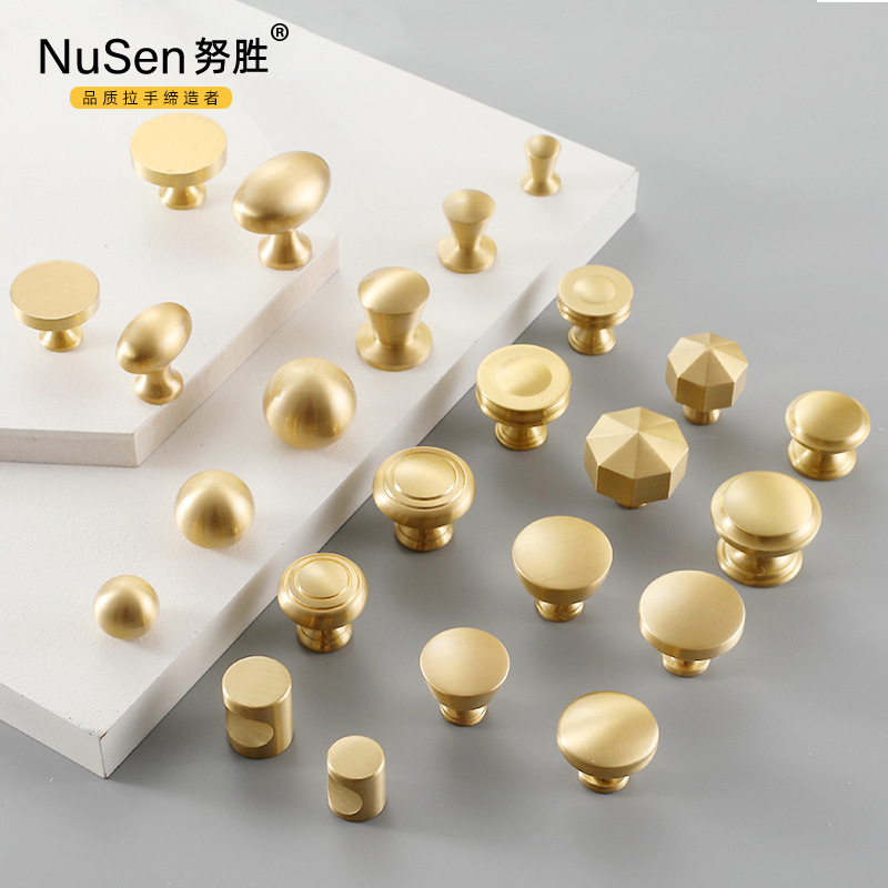Modern minimalist wardrobe, cabinet, and drawer handles—Nordic-style pure copper single-hole cabinet knobs in elegant gold-toned brass.