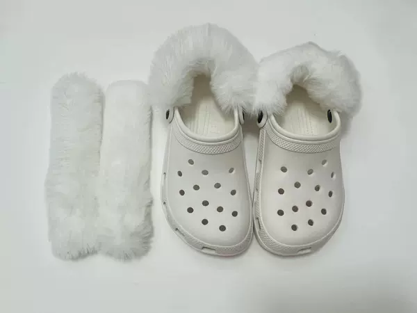 A pair of white long-hair shoe covers