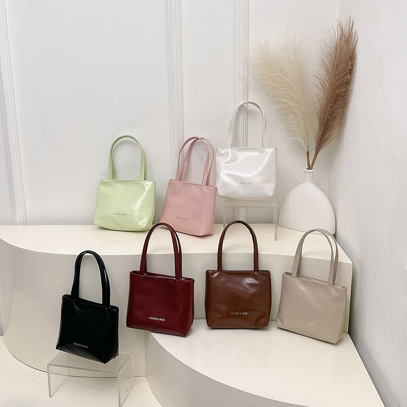 Casual coreano textura simple versátil bolso de viaje de mano de verano 2025 nuevo nicho de diseño de bolso de cubo de mano