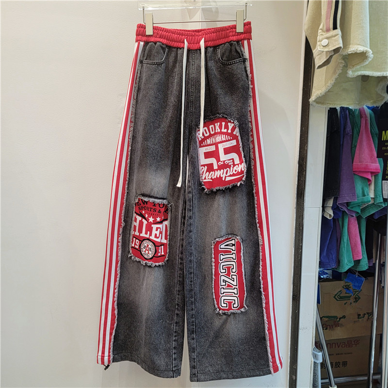 2026 primavera y verano nuevo estilo americano estilo callejero retro empalme jeans letras sueltas pegatinas pantalones largos de pierna ancha
