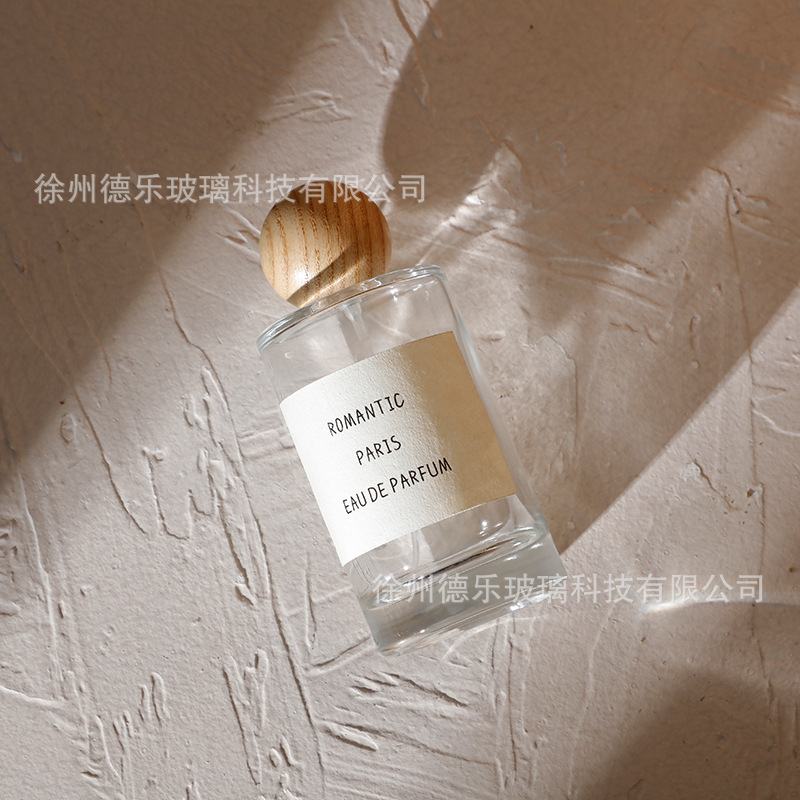 Venta al por mayor 50ml botella de perfume de vidrio cilíndrico botella de spray de perfume Cosméticos líquidos sub-botella con cubierta de bola de madera