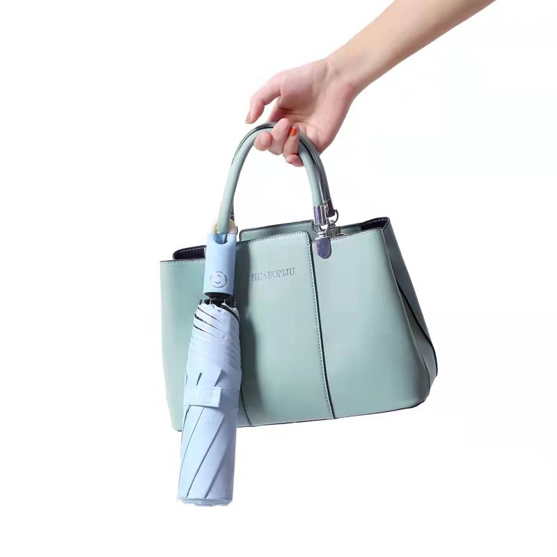 Llavero creativo paraguas pegamento negro paraguas plegable tríptico automático color sólido protección UV paraguas de sol paraguas de bloqueo