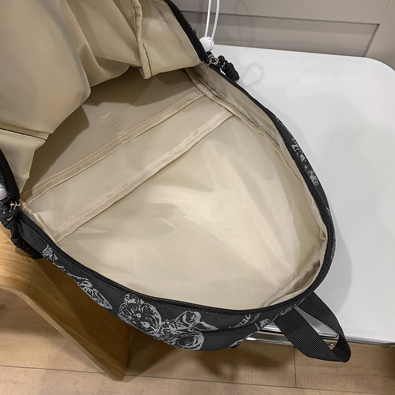 2025 nueva mochila de impresión de dibujos animados para estudiantes de secundaria femenina versión coreana universal mochila de viaje ligera simple