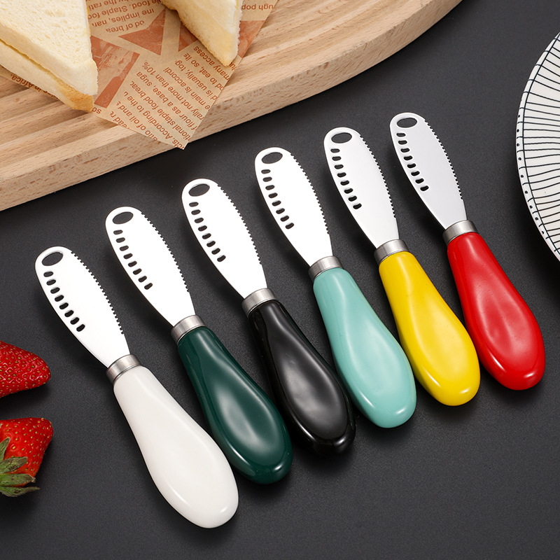 Cuchillo de mantequilla con mango de cerámica 430 Cuchillo de mantequilla de acero inoxidable con agujeros Cuchillo de queso doméstico Cuchillo de mermelada Cuchillo de queso crema