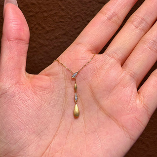 Little red book explosions tassel water drop necklace 2025 new ancient brushed gold micro inlay clavicle chain a generation of hair