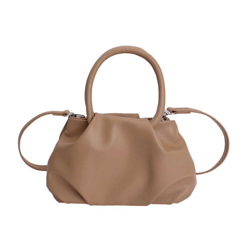 Alta sensación de mano pliegueada nube bolso de cubo para mujeres 2026 nuevo nicho de lujo ligero de moda perla bolsa de mochila