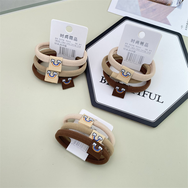 2022 nuevo estilo coreano accesorios para el cabello leche té color Banda para el cabello sin costuras etiqueta de tela Linda cuerda para el cabello 3 tarjetas cabeza cuerda banda de goma